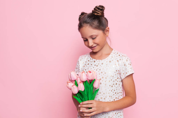 Portrait of a cute teenage girl in a stylish dress with a bouquet of flowers - Fotoğraf, Görsel