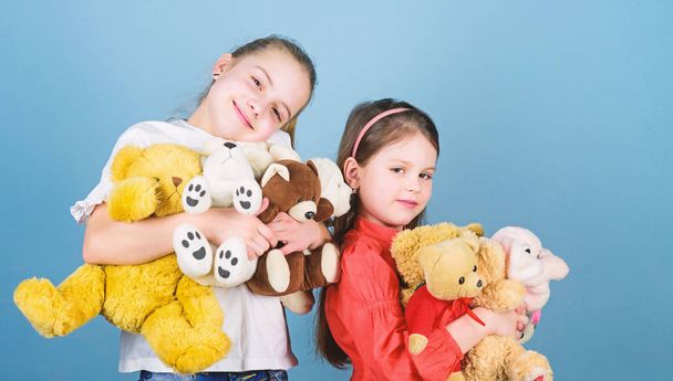 Sweet childhood. Childhood concept. Softness and tenderness. Laundry softener. Love and friendship. Kids adorable cute girls play soft toys. Happy childhood. Child care. Sisters best friends play - Foto, Imagen