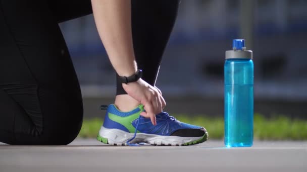 Zapatilla de deporte de mujer gorda corredora durante el atado de cordones
 - Imágenes, Vídeo