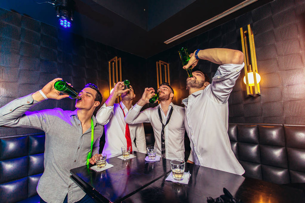 Group of young men toasting at a nightclub  - Photo, Image