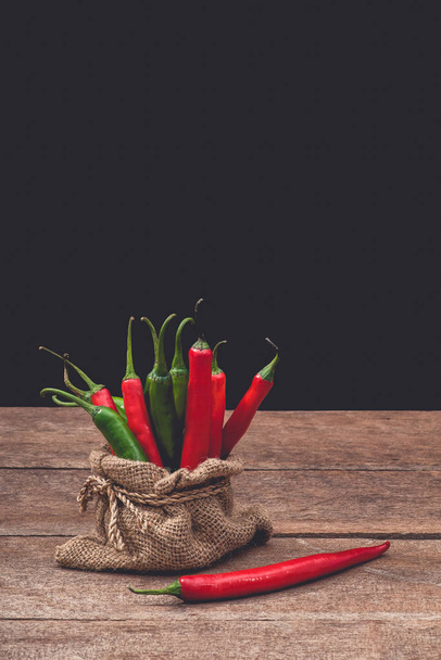 Red and green chili on wooden table background - Fotoğraf, Görsel
