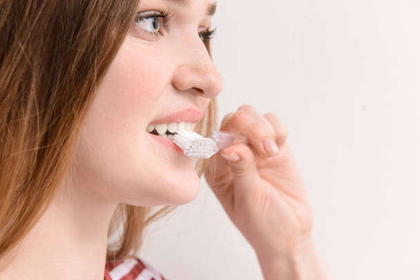 Woman with toothbrush on light background, closeup. Concept of dental hygiene - Фото, зображення