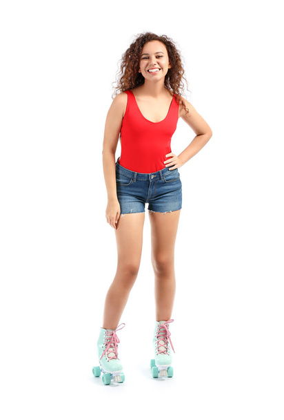 Beautiful young woman on roller skates against white background - Photo, Image
