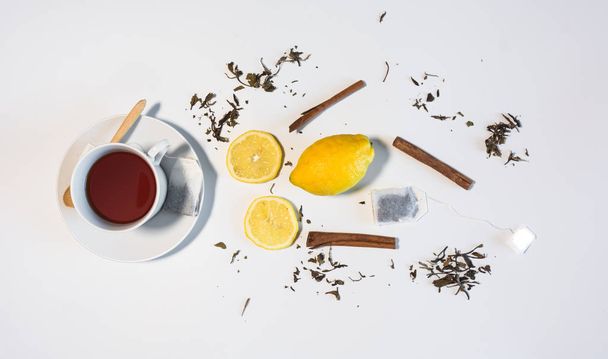 Black tea with lemon and cinnamon. - Photo, Image