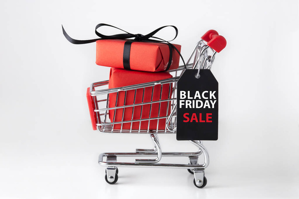 Black friday shopping cart with red gift box - Фото, изображение