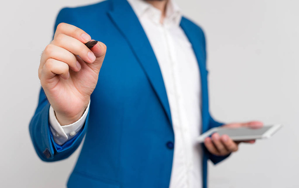 Businessman in blue suite and white shirt pointing with finger in empty space. Copy space with businessman pointing with finger. Business concept with man in the suite. - Photo, Image