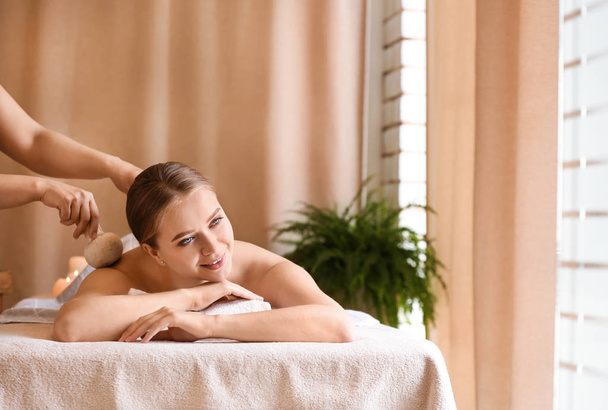 Beautiful young woman receiving massage in spa salon - Photo, Image