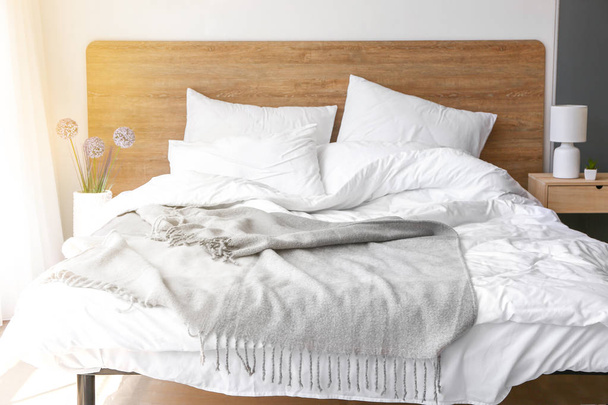 Soft plaid on bed in room - Foto, imagen