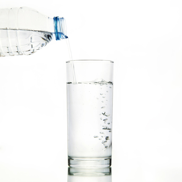 Botella de agua vierta agua al vidrio
 - Foto, Imagen