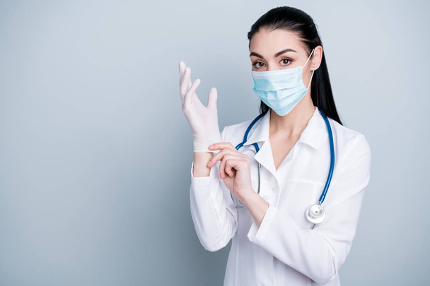 Close up photo beautiful she her lady doctor hospital preparing operation check equipment wearing facial mask rubber gloves phonendoscope white science costume isolated grey background - 写真・画像