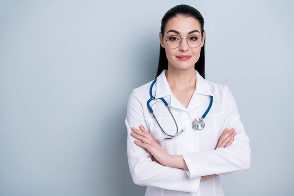 Close up photo beautiful amazing she her lady young doctor first working day hospital ready begin start crossed arms friendly wear phonendoscope white science costume specs isolated grey background - Φωτογραφία, εικόνα