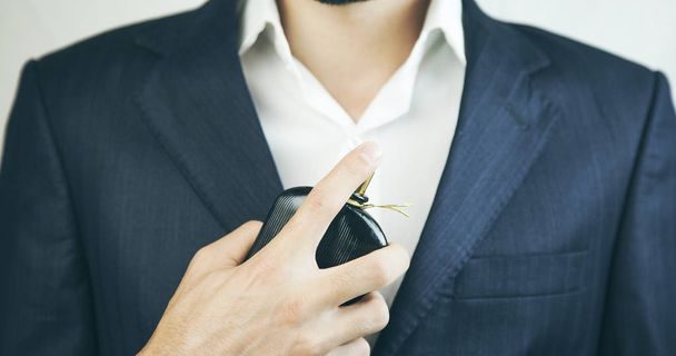 Handsome young businessman using perfume in studio - Zdjęcie, obraz