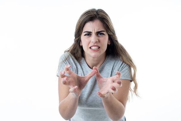 Close up of young attractive caucasian woman with an angry face. Looking mad and crazy shouting and making furious gestures. Isolated on white background. Facial expressions and emotions. - Foto, Imagen