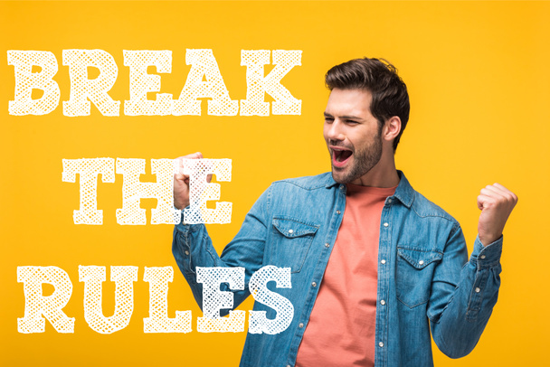 happy handsome man showing yes gesture isolated on yellow with break the rules illustration - Photo, Image