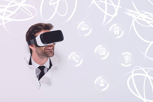 smiling man in Virtual reality headset in hole in wall with glowing cyberspace illustration - Foto, Bild