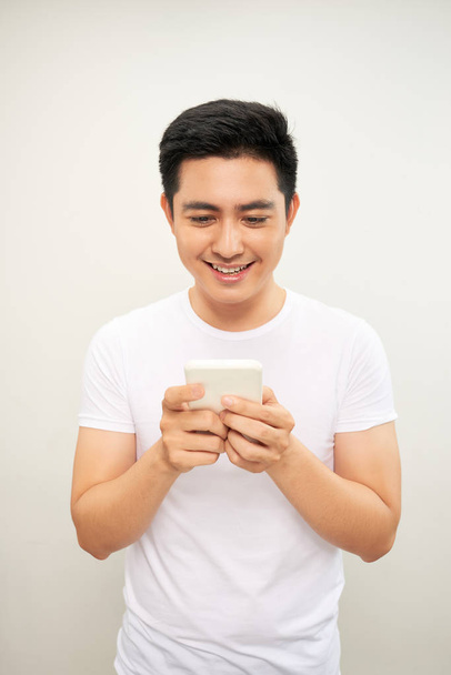 asiatische junge Mann Nutzung der Handy - Foto, Bild