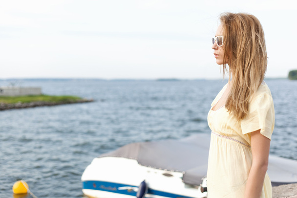 Young woman on sea background - 写真・画像