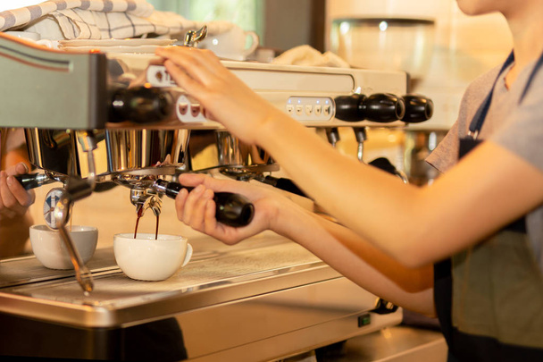 Barista making fresh coffee with machine in coffee shop or cafe. - Photo, Image