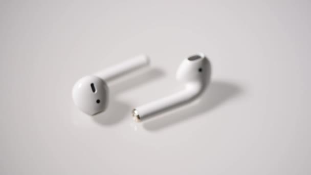 White wireless headphones are on a white background. Macro. - Footage, Video