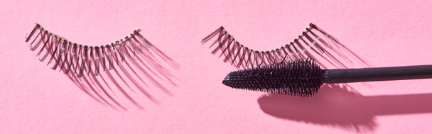 panoramic shot of brush for mascara and false eyelashes on pink background  - Fotoğraf, Görsel
