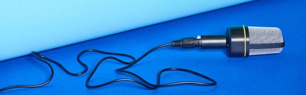 panoramic shot of black microphone with wire on colorful background  - Photo, Image