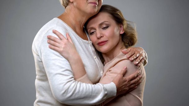 Senior lady hugging adult daughter, parenthood feeling, family understanding - Fotoğraf, Görsel