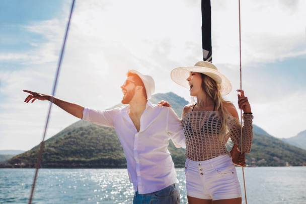 Loving couple spending happy time on a yacht at sea. Luxury vaca - Φωτογραφία, εικόνα