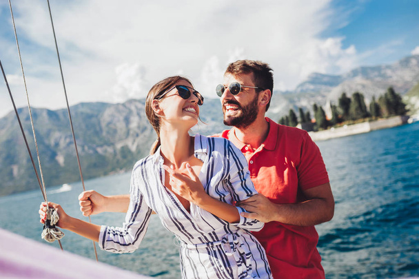 Loving couple spending happy time on a yacht at sea. Luxury vaca - Photo, Image