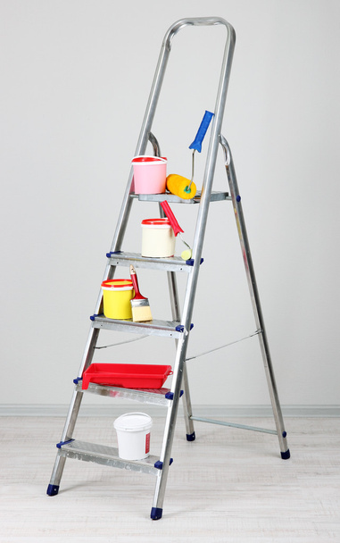 Metal ladder and paint in room - Φωτογραφία, εικόνα