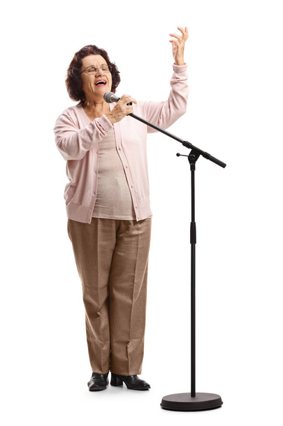 Elderly female singing on a microphone - Foto, imagen