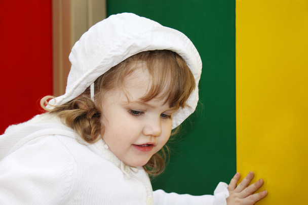 Beautiful little girl wearing white panama plays at playground - Valokuva, kuva