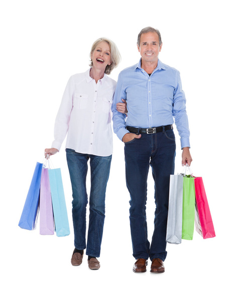 Mature Couple Holding Shopping Bags - 写真・画像