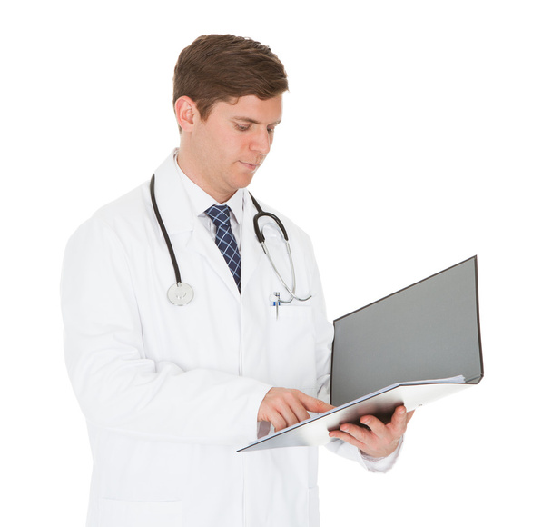 Male Doctor Reading Folder - Фото, зображення