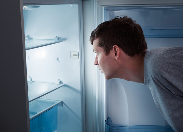Hungry man looking in refrigerator - Fotó, kép