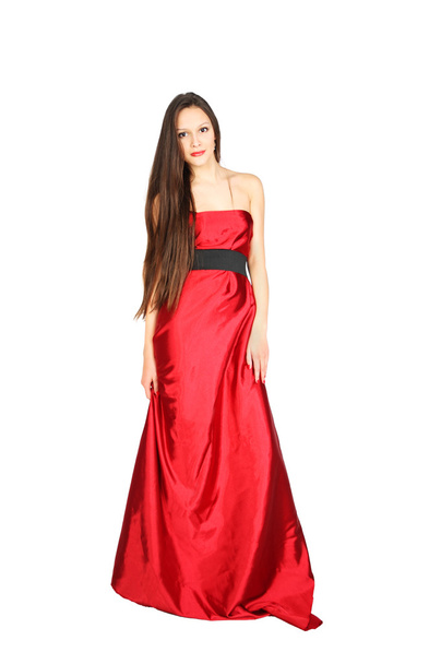 Young girl wearing long red dress stands isolated on white backg - Photo, image