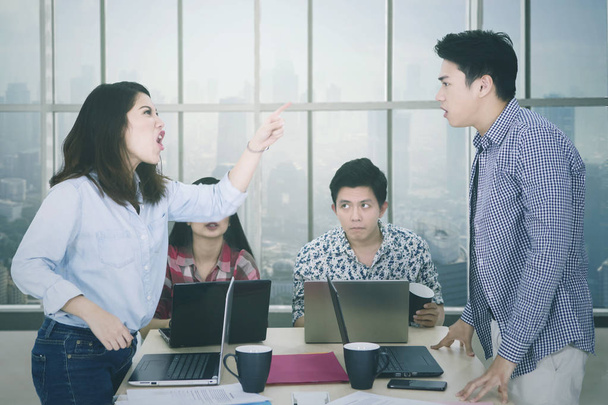 Angry entrepreneur accusing her friend in meeting - Fotó, kép