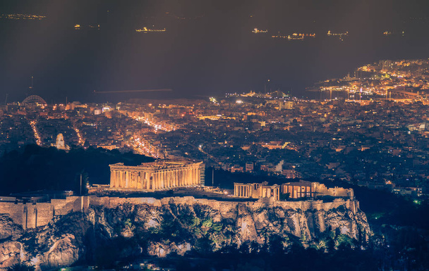 Night view of famous Acropolis in Athens in Greece in warm colors. - Photo, Image