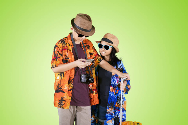 Two little travelers using a phone in the studio - Valokuva, kuva