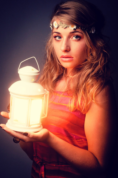 beautiful girl with lantern seeking in night. Vintage retouching - Fotó, kép
