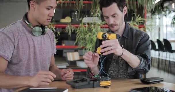 Designers working on a robotic arm - Felvétel, videó