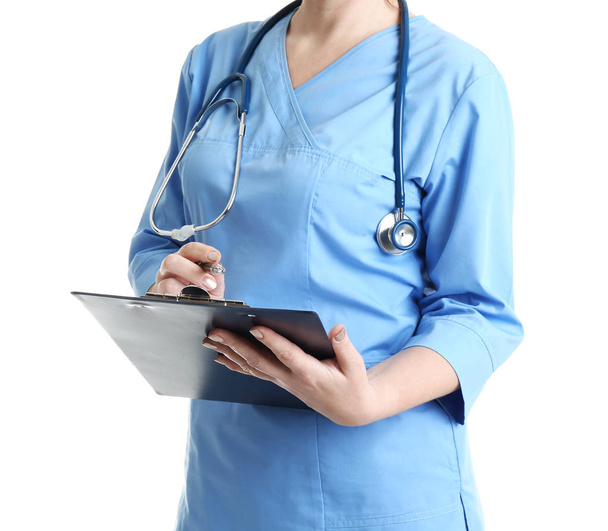 Doctor with clipboard in uniform on white background, closeup. Medical service - Photo, image