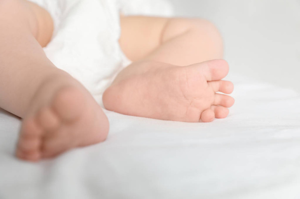 Little baby with cute feet on bed sheet, closeup - Photo, Image