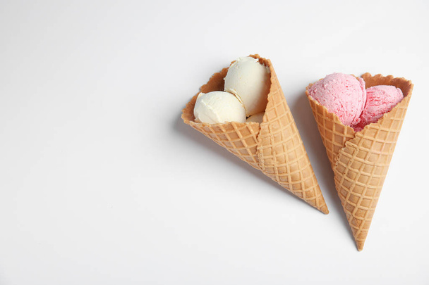 Delicious ice creams in wafer cones on white background, top view - Foto, imagen