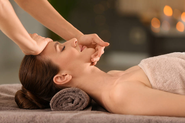 Beautiful young woman enjoying massage in spa salon - Fotografie, Obrázek