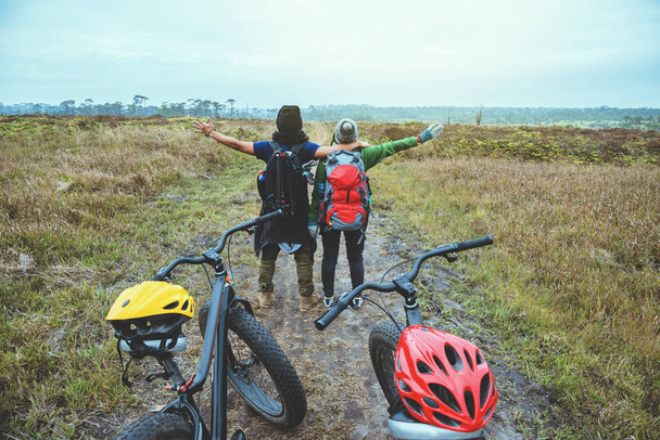  asiatische Liebhaber Frau und Mann Reisen fotografieren die Natur. Reisen Sie entspannt Fahrrad fahren Wildnis in der wild.stand auf der Linie. auf der Wiese im Wald. Thailand  - Foto, Bild