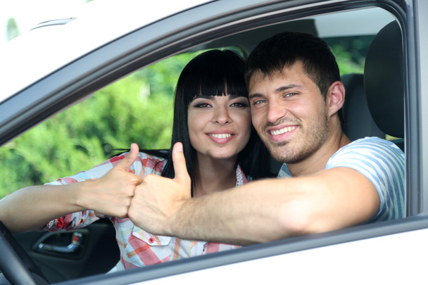 Beautiful happy young couple driving car - Fotoğraf, Görsel
