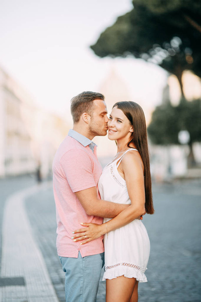 Happy couple at dawn strolling in Italy. Morning summer photo shoot in Rome.  - Photo, Image