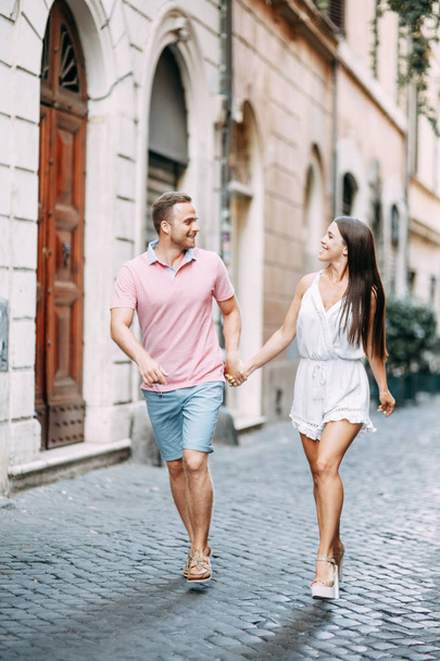 Happy couple at dawn strolling in Italy. Morning summer photo shoot in Rome.  - Φωτογραφία, εικόνα