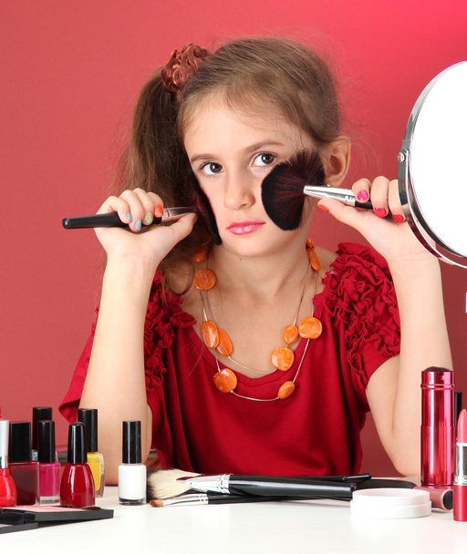 little girl in her mother's dress with make up brushes - Fotografie, Obrázek