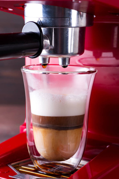 Coffee machine preparing cappuccino in double glass, close up - Photo, Image